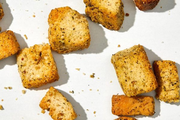 Kooshy sourdough croutons up close, seasoning and browning